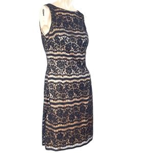 Little black dress is an intricate black lace with black black beading nude